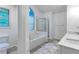 Bright bathroom with a large tub, glass-enclosed shower, and double sink vanity offers a spa-like retreat at 2869 Hickory Run Cir, Duluth, GA 30096