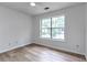 Bright, spacious bedroom with wood-look floors and a large window at 2869 Hickory Run Cir, Duluth, GA 30096