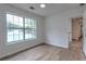 Bright bedroom featuring wood-look floors and a large window with a neighborhood view at 2869 Hickory Run Cir, Duluth, GA 30096