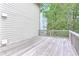A spacious deck with wood railing overlooking the trees offers a great place for entertaining at 2869 Hickory Run Cir, Duluth, GA 30096
