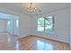 Elegant dining room with hardwood floors, crown molding, chandelier, and a large window at 2869 Hickory Run Cir, Duluth, GA 30096