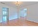 Dining room with hardwood floors, chandelier, and an open doorway leading to another room at 2869 Hickory Run Cir, Duluth, GA 30096
