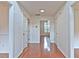 Hallway featuring hardwood floors, white walls, and multiple doorways leading to various rooms at 2869 Hickory Run Cir, Duluth, GA 30096
