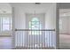 Upstairs hallway featuring a window and railing offers a light-filled transition between spaces at 2869 Hickory Run Cir, Duluth, GA 30096