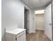 Hallway with ample storage cabinets, neutral walls, and updated vinyl floors at 2869 Hickory Run Cir, Duluth, GA 30096