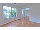 Living room with hardwood floors, a large window, and an open doorway to the dining room at 2869 Hickory Run Cir, Duluth, GA 30096