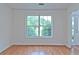 Living room featuring hardwood floors, a large window, and a doorway to the foyer at 2869 Hickory Run Cir, Duluth, GA 30096