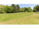 Expansive backyard with lush green grass and a path, perfect for outdoor activities at 3794 Ashford Lake Ne Ct, Brookhaven, GA 30319