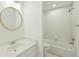 Updated bathroom featuring modern fixtures, a round mirror, and tiled shower at 3794 Ashford Lake Ne Ct, Brookhaven, GA 30319
