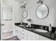 Elegant bathroom featuring dual sinks with granite countertops and a shower at 3794 Ashford Lake Ne Ct, Brookhaven, GA 30319