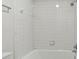 Clean, bright bathroom features white tiled walls and a shower-tub combination at 3794 Ashford Lake Ne Ct, Brookhaven, GA 30319
