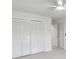 Bright bedroom features a ceiling fan, carpet, and large closet at 3794 Ashford Lake Ne Ct, Brookhaven, GA 30319