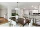 Dining area with a wooden table and white chairs next to the kitchen and living room at 3794 Ashford Lake Ne Ct, Brookhaven, GA 30319