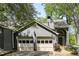 Charming home featuring a two-car garage and beautifully painted exterior with lovely trees surrounding the property at 3794 Ashford Lake Ne Ct, Brookhaven, GA 30319