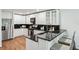 Kitchen featuring a breakfast bar, white cabinets, stainless steel appliances, and hardwood floors at 3794 Ashford Lake Ne Ct, Brookhaven, GA 30319