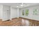 Bright living room featuring laminate floors, a ceiling fan, and access to the outside at 3794 Ashford Lake Ne Ct, Brookhaven, GA 30319