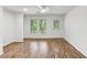 Open-concept living room featuring laminate floors, a ceiling fan, and lots of natural light at 3794 Ashford Lake Ne Ct, Brookhaven, GA 30319