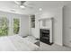 Cozy main bedroom featuring a fireplace, ceiling fan, and large windows at 3794 Ashford Lake Ne Ct, Brookhaven, GA 30319