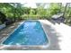 Refreshing in-ground pool surrounded by a fence and lush greenery, perfect for enjoying the outdoors at 3794 Ashford Lake Ne Ct, Brookhaven, GA 30319