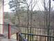 Enjoy the outdoor views from the balcony with steel rails, overlooking trees and landscape at 412 Hawkstone Way, Alpharetta, GA 30022