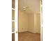 Well-lit bedroom with carpet, a ceiling fan, and a door opening to another room at 412 Hawkstone Way, Alpharetta, GA 30022