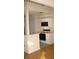Bright kitchen with white cabinets and modern appliances, complete with breakfast bar at 412 Hawkstone Way, Alpharetta, GA 30022