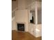 Charming living room features a cozy fireplace and seamless access to the kitchen at 412 Hawkstone Way, Alpharetta, GA 30022