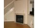 Charming living room features a cozy fireplace and seamless access to the staircase at 412 Hawkstone Way, Alpharetta, GA 30022