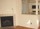 Cozy living room with a fireplace and easy access to the kitchen area at 412 Hawkstone Way, Alpharetta, GA 30022