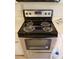 Stainless steel and black Whirlpool brand stove with oven, ceramic top and silver knobs at 412 Hawkstone Way, Alpharetta, GA 30022