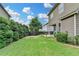A well maintained backyard features green grass, privacy bushes, and an outdoor seating area for relaxing or entertaining at 4215 Cordova Ln, Cumming, GA 30028