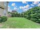 Picture perfect backyard featuring green grass and mature, lush landscaping providing privacy at 4215 Cordova Ln, Cumming, GA 30028