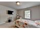 Cozy bedroom featuring a floral bed spread, mounted television, and neutral walls at 4215 Cordova Ln, Cumming, GA 30028