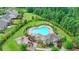 Aerial view featuring a large community pool, play structure, and manicured landscaping in a Gathering friendly neighborhood at 4215 Cordova Ln, Cumming, GA 30028
