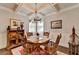 Elegant dining room with a coffered ceiling, chandelier, and traditional wood furniture at 4215 Cordova Ln, Cumming, GA 30028