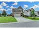 Beautiful two-story home with stone accents, a spacious driveway, and a lush green lawn at 4215 Cordova Ln, Cumming, GA 30028