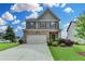Charming two-story home with a mix of stone and siding, a well-kept lawn, and a driveway at 4215 Cordova Ln, Cumming, GA 30028