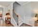 Elegant foyer featuring hardwood floors, a staircase with wooden railing, and wainscoting at 4215 Cordova Ln, Cumming, GA 30028