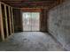 Unfinished basement with exposed framing and a sliding glass door to the backyard at 4701 Flat Shoals Rd # 56D, Union City, GA 30291