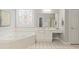 Bright bathroom features a soaking tub and a vanity with a decorative flower window at 6275 Glen Oaks Ln, Atlanta, GA 30328