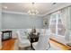 Elegant dining room featuring a modern chandelier, hardwood floors, and large window at 6275 Glen Oaks Ln, Atlanta, GA 30328