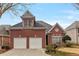 Charming two-story brick home with a two-car garage and manicured lawn at 6275 Glen Oaks Ln, Atlanta, GA 30328
