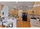 Open kitchen with breakfast bar seating, lots of cabinets, and views to living space at 6275 Glen Oaks Ln, Atlanta, GA 30328