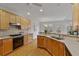 U-shaped kitchen providing a breakfast bar and sink with view of the dining area at 6275 Glen Oaks Ln, Atlanta, GA 30328