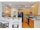 Well-lit kitchen featuring light wood cabinetry, stainless steel appliances, and a breakfast bar at 6275 Glen Oaks Ln, Atlanta, GA 30328