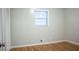 Cozy bedroom featuring hardwood floors and a window with natural light at 6470 Sherwood Trl, Austell, GA 30168