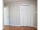 Bedroom with hardwood floors and closet with louvered doors at 6470 Sherwood Trl, Austell, GA 30168