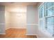 Dining room with hardwood floors and bright window at 6470 Sherwood Trl, Austell, GA 30168