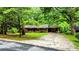 Ranch-style home with a long driveway and mature trees providing ample shade at 6470 Sherwood Trl, Austell, GA 30168
