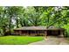 Lovely brick ranch home with a long driveway, carport, and mature trees at 6470 Sherwood Trl, Austell, GA 30168
